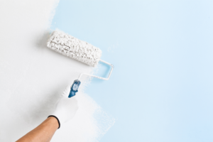 a person painting an interior wall