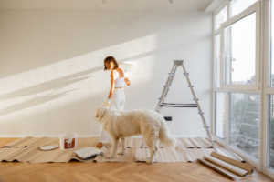 a homeowner painting with their dog’s assistance 